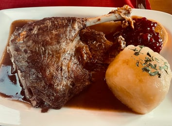 Christmas dinner in Austria, roast goose with dumplings, gravy and sauce